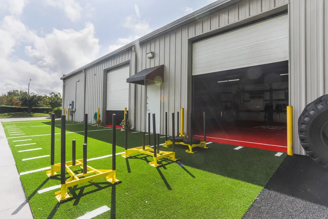 Outside TNDO GYM: outdoor turf and bay door