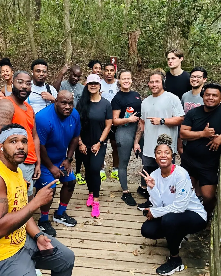 TNDO Run Club members gather on a wooded boardwalk trail