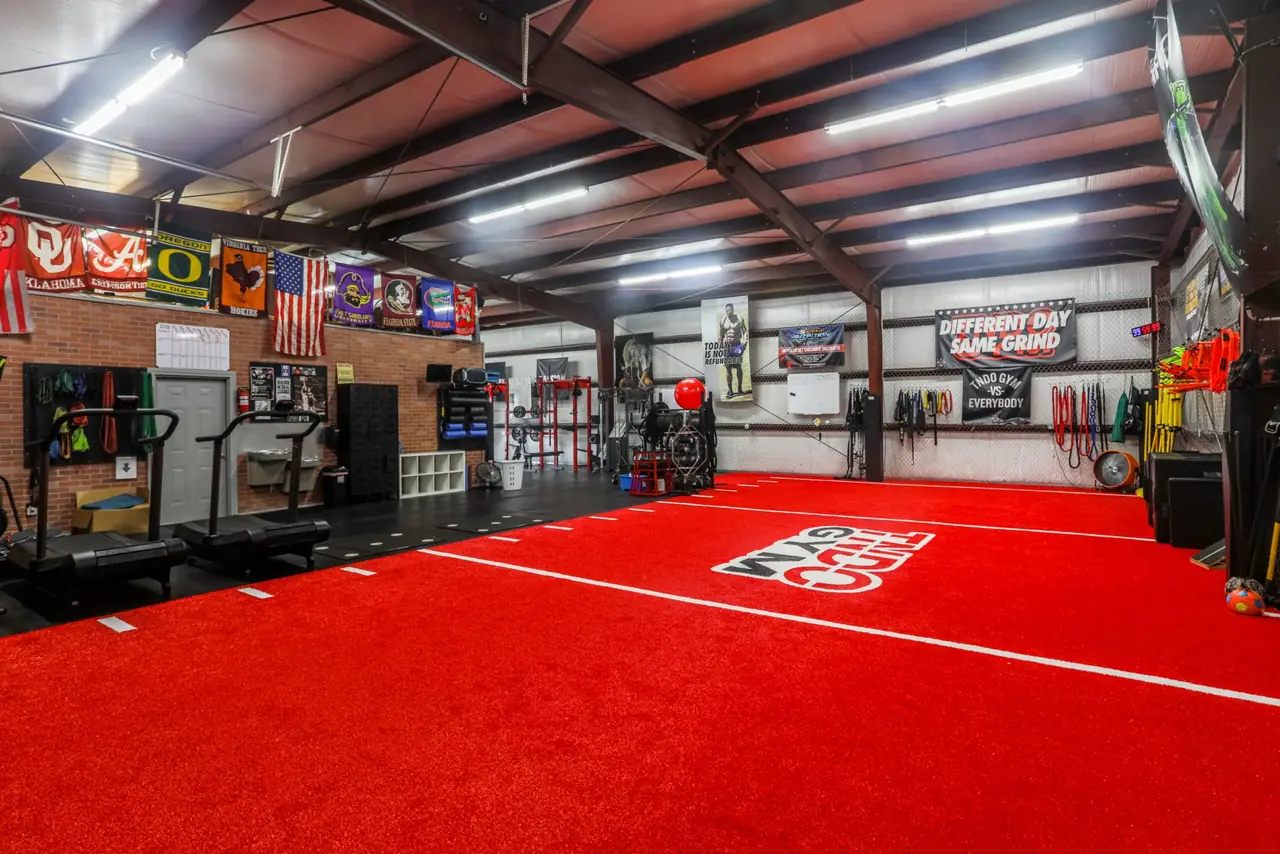 Red turf sprint lane at TNDO GYM