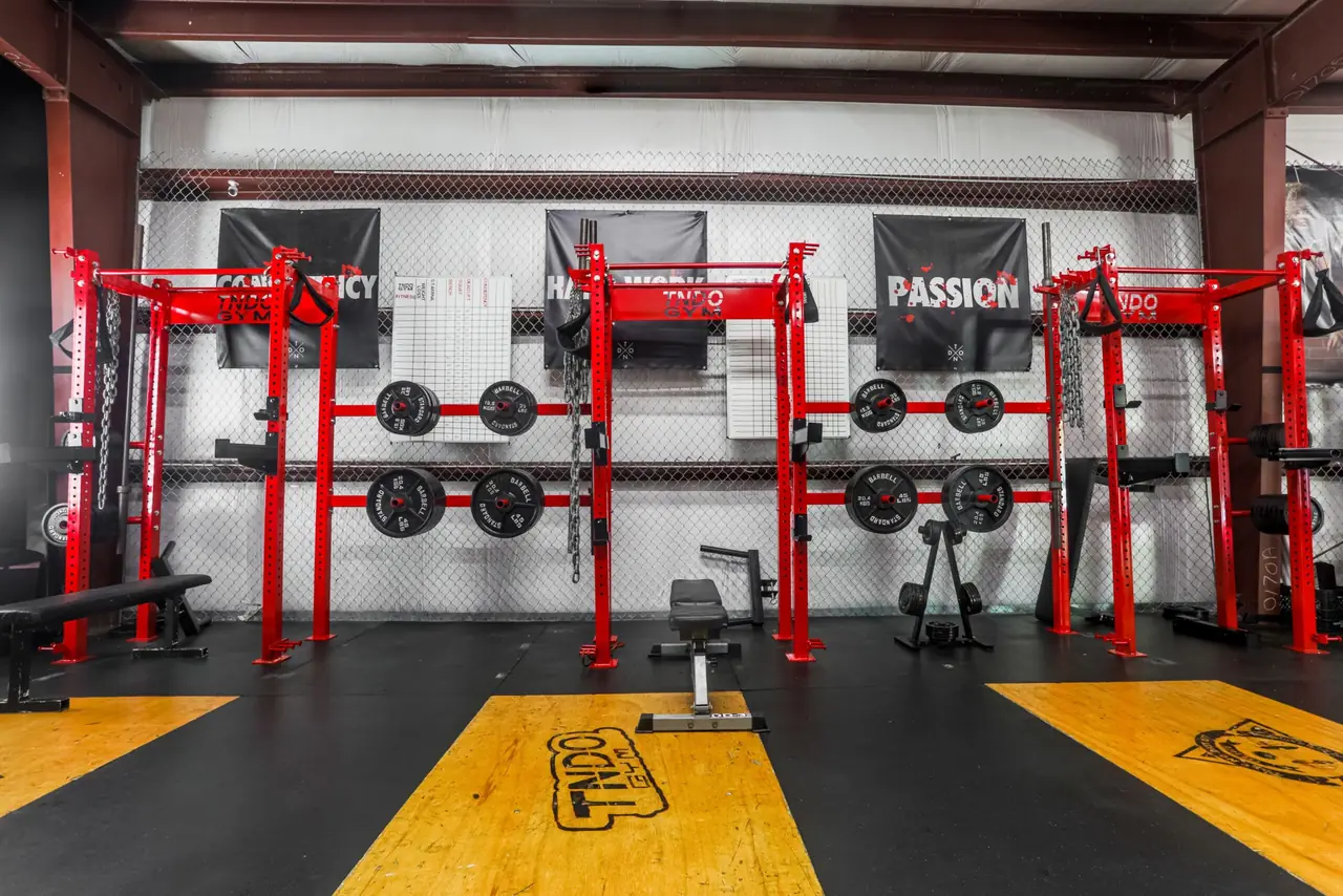 Red squat racks at TNDO GYM